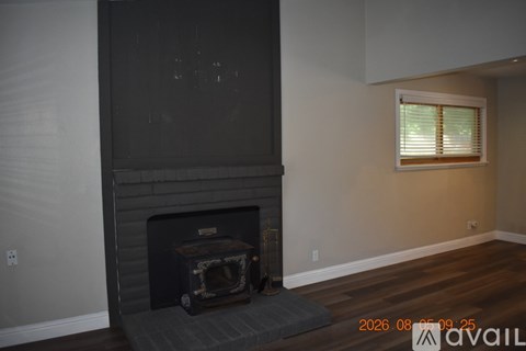 A fireplace in a room with a window.