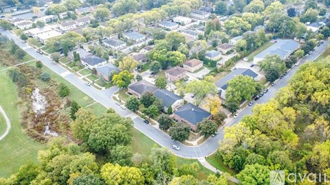 A bird's eye view of a residential area with houses and trees.