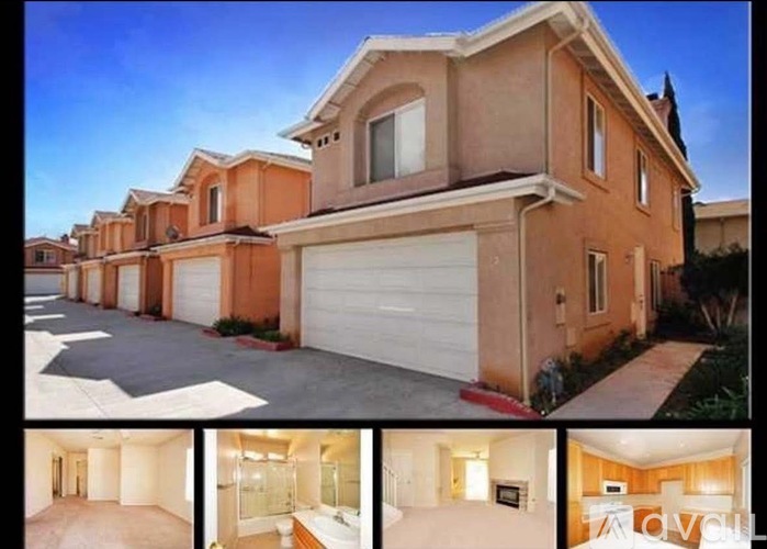 A beige house with a garage and a driveway.
