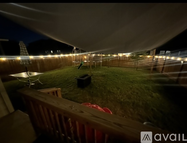 A backyard with a lawn and a deck.