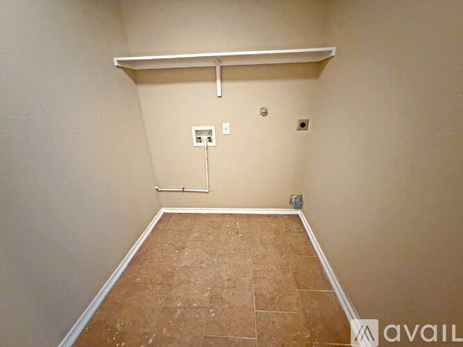 A room with a wooden floor and a white shelf.