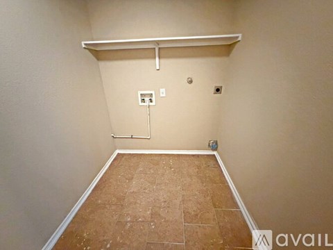 A room with a wooden floor and a white shelf.