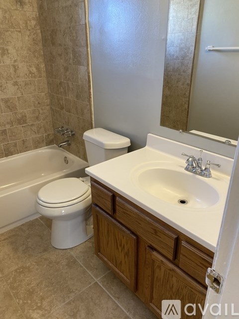 A bathroom with a toilet, sink, and bathtub.