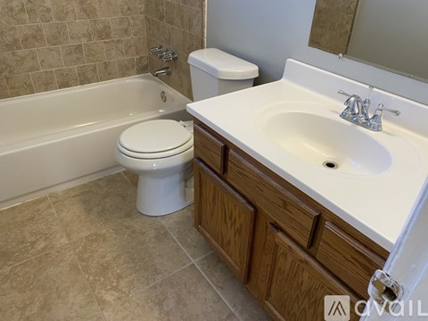 A white toilet sits next to a sink in a bathroom.