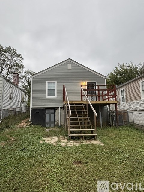 A house with a grey exterior and a wooden deck.