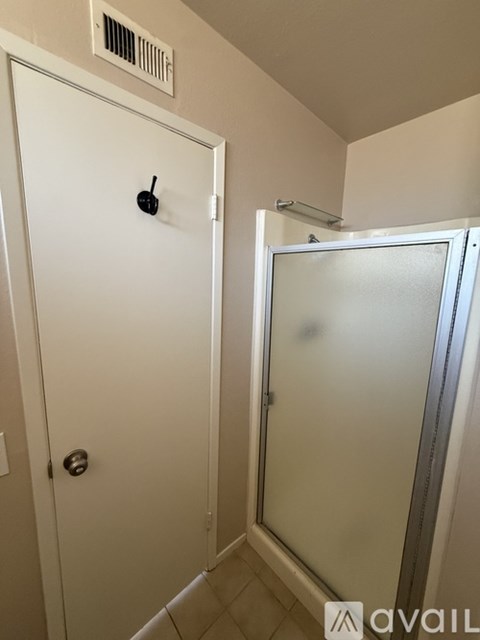 A white door with a black handle and a window above it.