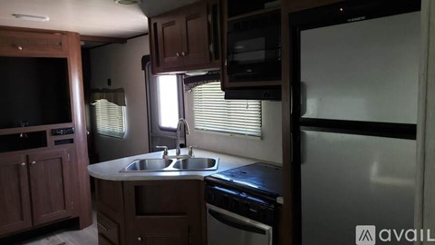A kitchen with a sink, stove, and refrigerator.