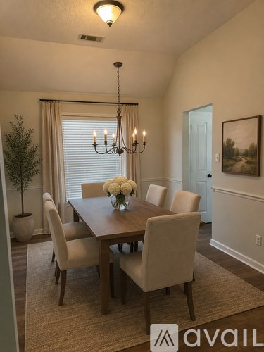 A dining room with a wooden table and chairs.