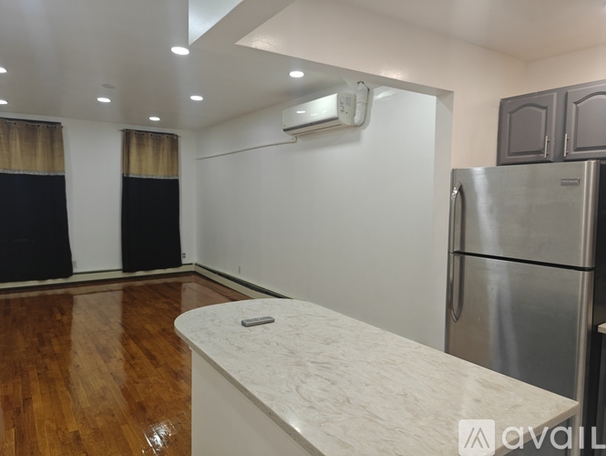 A kitchen with a refrigerator and a counter.