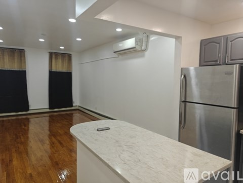 A kitchen with a refrigerator and a counter.