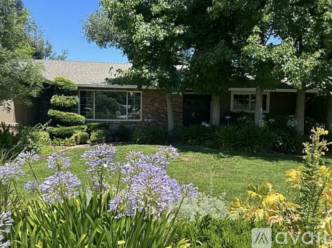 A house with a garden in front of it.