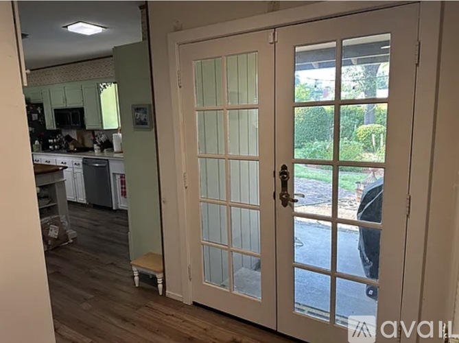 A white door with a glass panel is open.