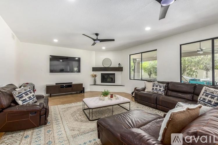 A living room with brown leather couches and a white coffee table.