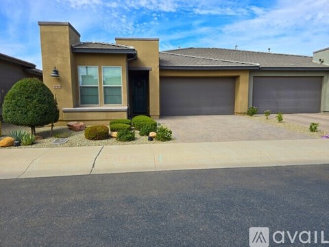 A house with a garage and a driveway in front of it.