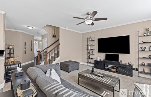 A living room with a grey couch and a black coffee table.