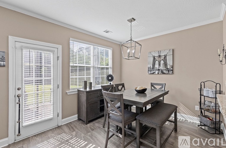 A dining room with a table and chairs.