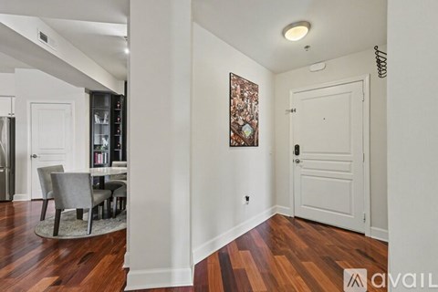 A hallway with a white door and a brown floor.