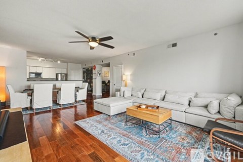 A living room with a white couch and a wooden coffee table.