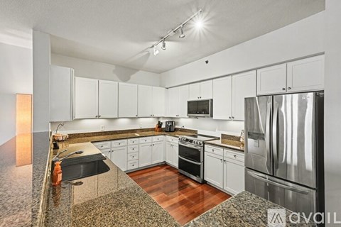 A kitchen with granite countertops and stainless steel appliances.