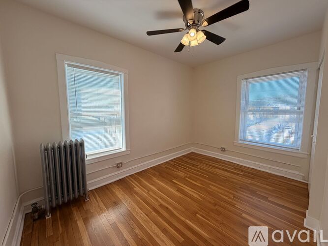 A room with wooden floors and a ceiling fan.