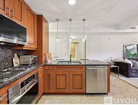 A kitchen with wooden cabinets and a granite countertop.