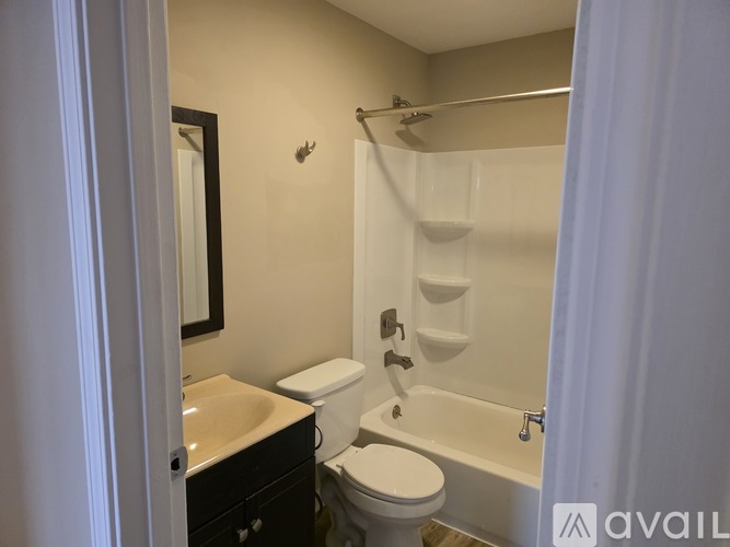 A bathroom with a toilet, sink, and bathtub.
