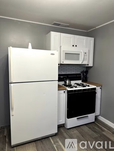 A white refrigerator and oven in a kitchen.