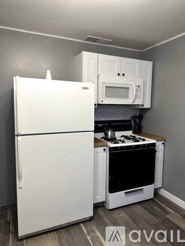A white refrigerator and oven in a kitchen.