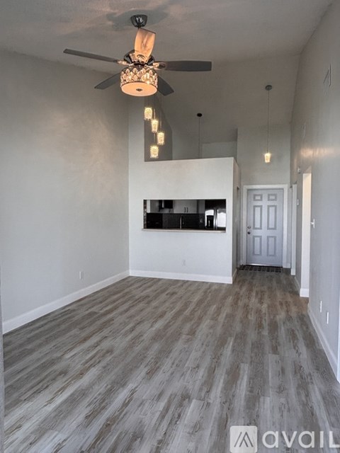 A room with a ceiling fan and lights.