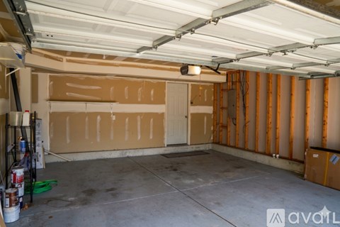 A garage with a white ceiling and a concrete floor.