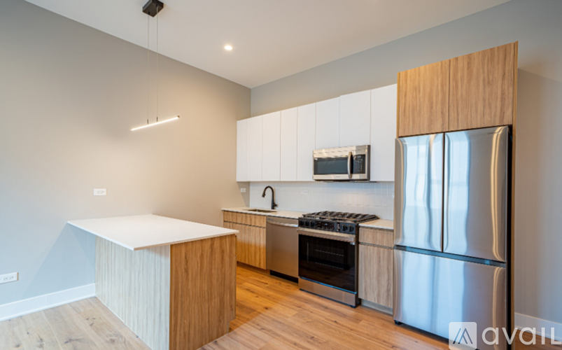 A kitchen with a white countertop and wooden cabinets.