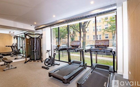 A gym with treadmills, exercise bikes, and other equipment.