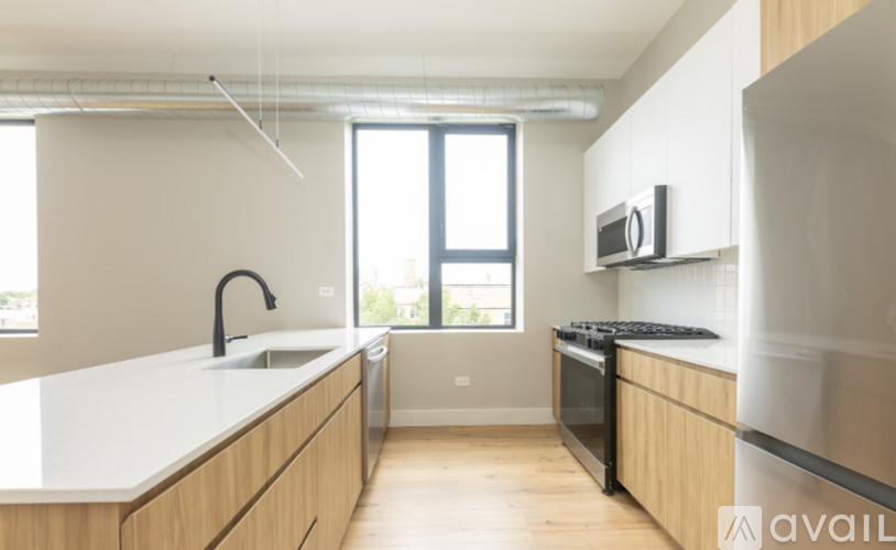 A kitchen with wooden cabinets and a black stove top oven.