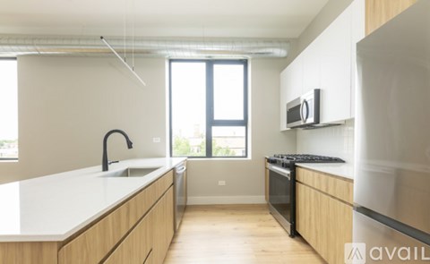 A kitchen with wooden cabinets and a black stove top oven.