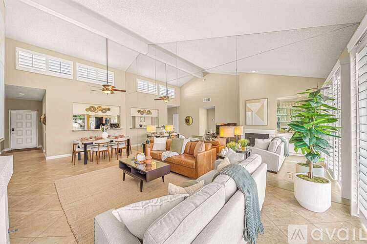A living room with a grey couch and a coffee table.