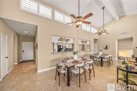A dining room with a table set for six people.
