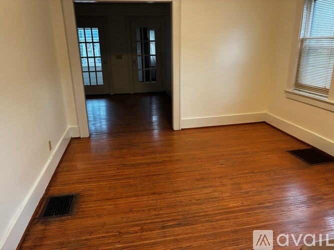 A room with wooden floors and white walls.