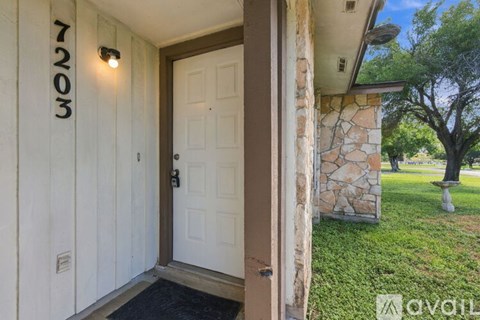 A white door with a black mat in front of it.