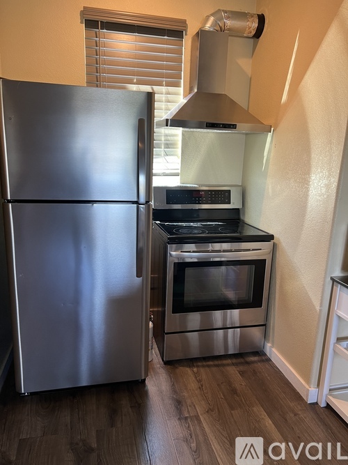 A kitchen with a stainless steel refrigerator and oven.