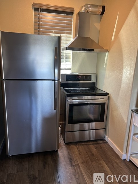 A kitchen with a stainless steel refrigerator and oven.