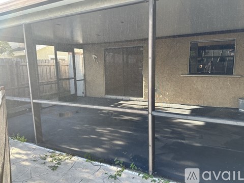 A concrete building with a glass door and windows.