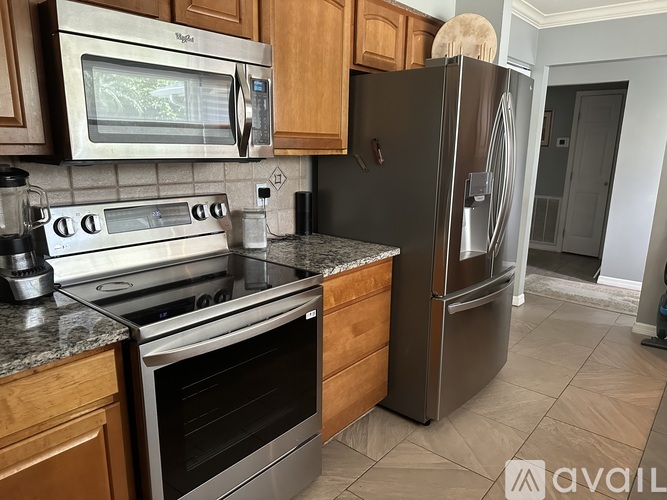 A kitchen with a stainless steel refrigerator and oven.