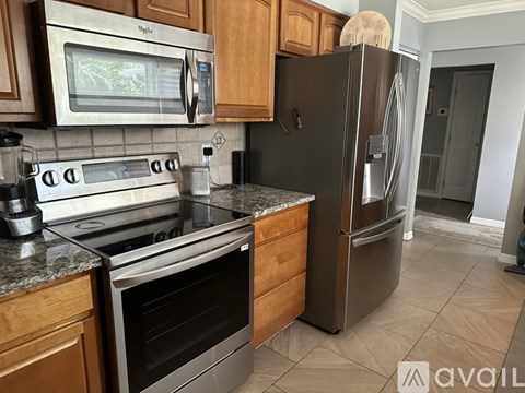 A kitchen with a stainless steel refrigerator and oven.