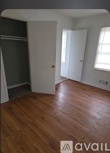 A room with wooden floors and a white door.