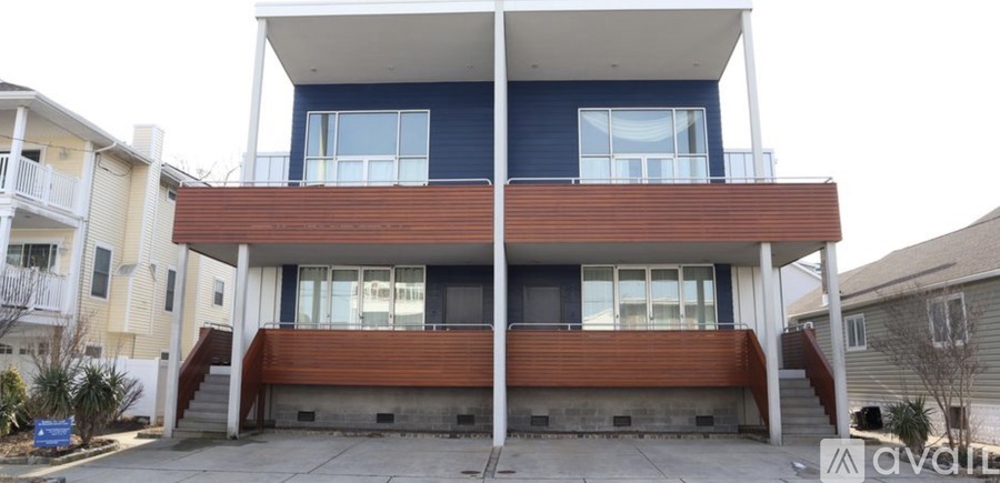 A two story house with a balcony on the second floor.