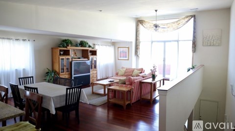 A living room with a dining table and chairs.