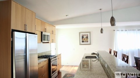 A kitchen with wooden cabinets and a granite countertop.