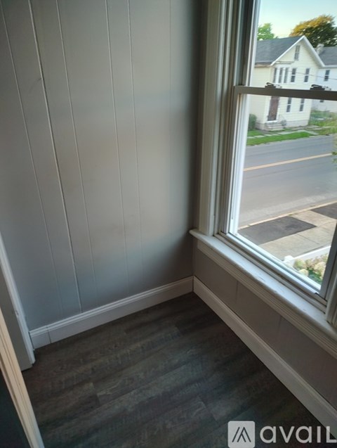 A room with a window overlooking a street.