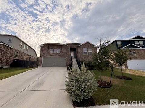 A house with a driveway and a garage is shown in the image.