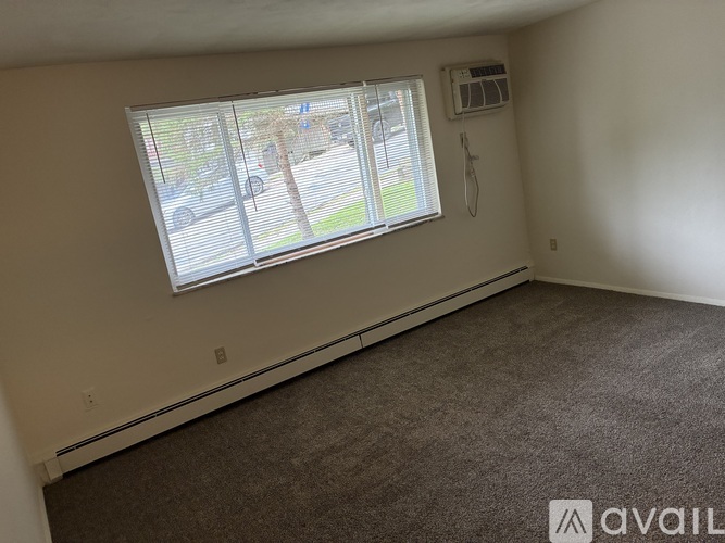 A room with a window and a car outside.